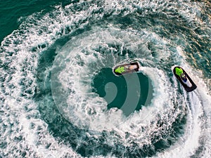 People are playing a jet ski in the sea.Aerial view. Top view.amazing nature background.The color of the water and beautifully br