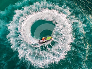 People are playing a jet ski in the sea.Aerial view. Top view.amazing nature background.The color of the water and beautifully br