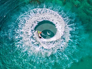 People are playing a jet ski in the sea.Aerial view. Top view.amazing nature background.The color of the water and beautifully br