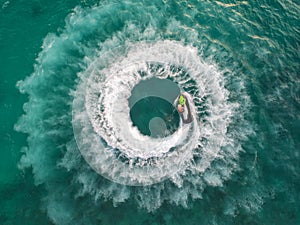 People are playing jet ski at sea during the holidays. Aerial view and top view