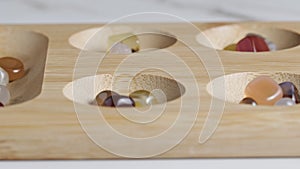 People playing mancala game on table