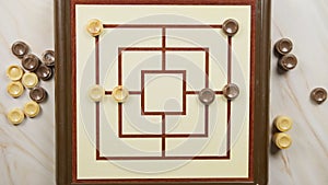 People Are Playing Nine Men Morris Board Game top view