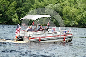 People on pontoon in parade on the river to celebrate Independence Day, the Fourth of July photo