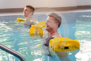 People in pool during water gymnastics physiotherapy