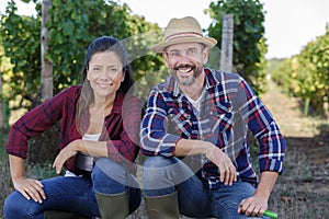 people posing in vineyard