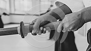 People practicing aikido in a dojo background.