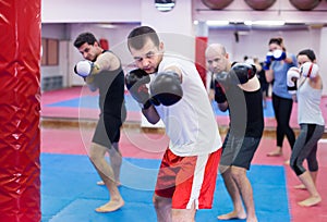 People practicing boxing punches