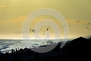 People practicing Kite Surf at sunset in the Barra da Tijuca beach, Rio de Janeiro, Brazil.