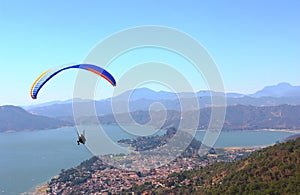People practicing paragliding over the lake of valle de bravo, mexico IX
