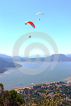 People practicing paragliding over the lake of valle de bravo, mexico XX