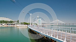 People practicing sports on the Passeio Ribeirinho over the Tagus River. Park of Nations timelapse hyperlapse photo