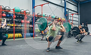 People practicing weightlifting in the gym