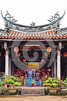 People pray for god in traditional oriental heritage temple in Taiwan