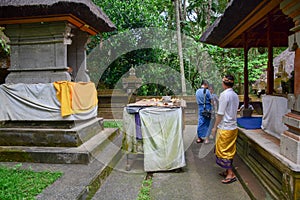 People praying at the Elephant temple in Bali, Indonesia