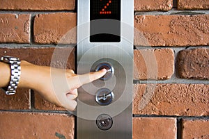 People pressing elevator button