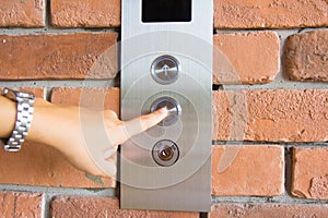 People pressing elevator button