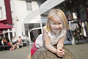 People , pretty litlle girl three on a crowded street. Summer sunny weather