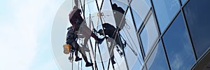 People professionally work at height wash windows photo