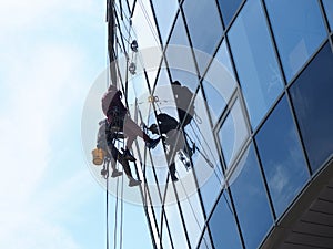 People professionally work at height wash windows photo