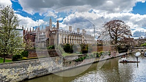 People punting on the river Cam with Clare College and Clare Bridge in background