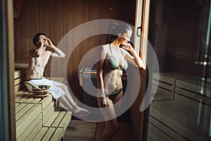 People pursuing healthy lifestyles relaxing in sauna