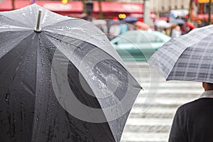 People with rain umbrellas in the rainy city