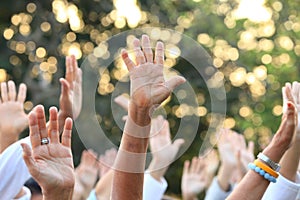 People raise their hands up for protest and uprising in demonstration event for unity and unanimous vote photo