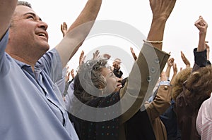 People With Raised Hands In Rally