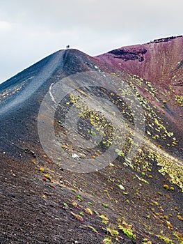 People on range between craters on Mount Etna