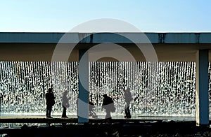 People refreshing in the fountain