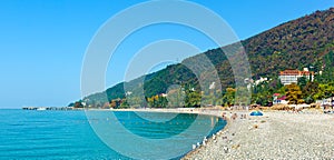 People relax on beautiful beach of Old Gagra on the Black Sea in Abkhazia