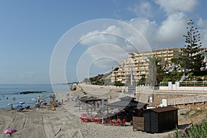 People relax on the sandy beach of Playa de Aguamarina, province of Alicante, Spain photo