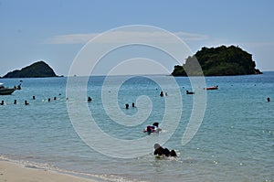 People relaxing on the beach.Tourists come and play the sea.