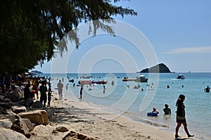 People relaxing on the beach.Tourists come and play the sea.