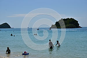 People relaxing on the beach.Tourists come and play the sea.