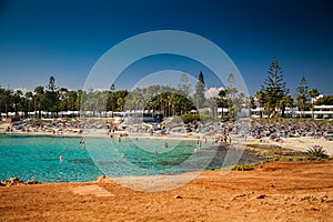 People relaxing at Nissi beach in Cyprus photo