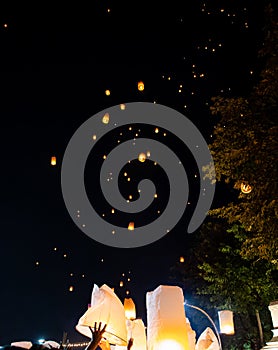 People releasing paper lanterns during Loi Krathong and Yi Peng festival