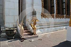 People removed their shoes before going into the main hall of a buddhist temple (Thailand) photo