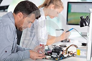 people repairing computer in workshop