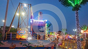 People rest in amusement park at early evening time
