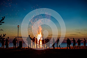 People resting near big bonfire outdoor