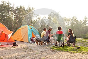 People resting near camping tent