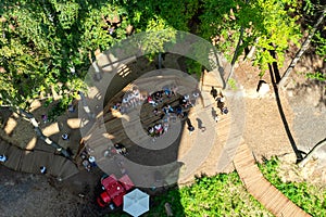 People are resting in a recreation area in the middle of the forest. View from above