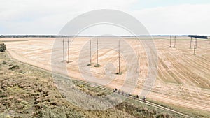 People ride bicycles in nature. Group of cyclists riding gravel bikes on countryside road, taking part in bike competition. Bike g