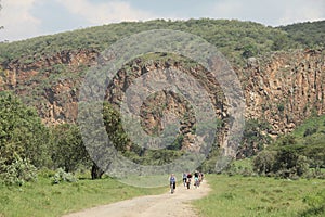 People ride bikes through the Hell's Gate National Park in Kenya
