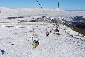 People ride on cableway at winter day in Cahkadzor photo