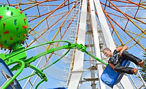 People ride rides in an amusement Park.