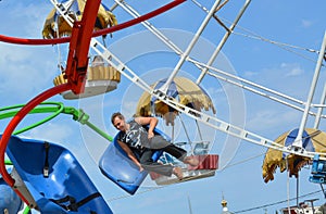 People ride rides in an amusement Park.