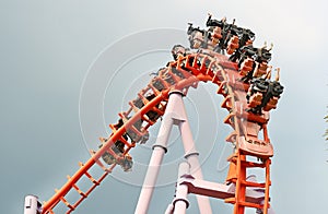 People ride on roller Coaster.