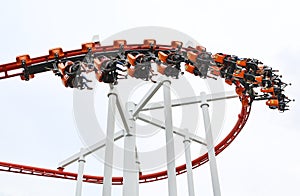 People ride on roller Coaster